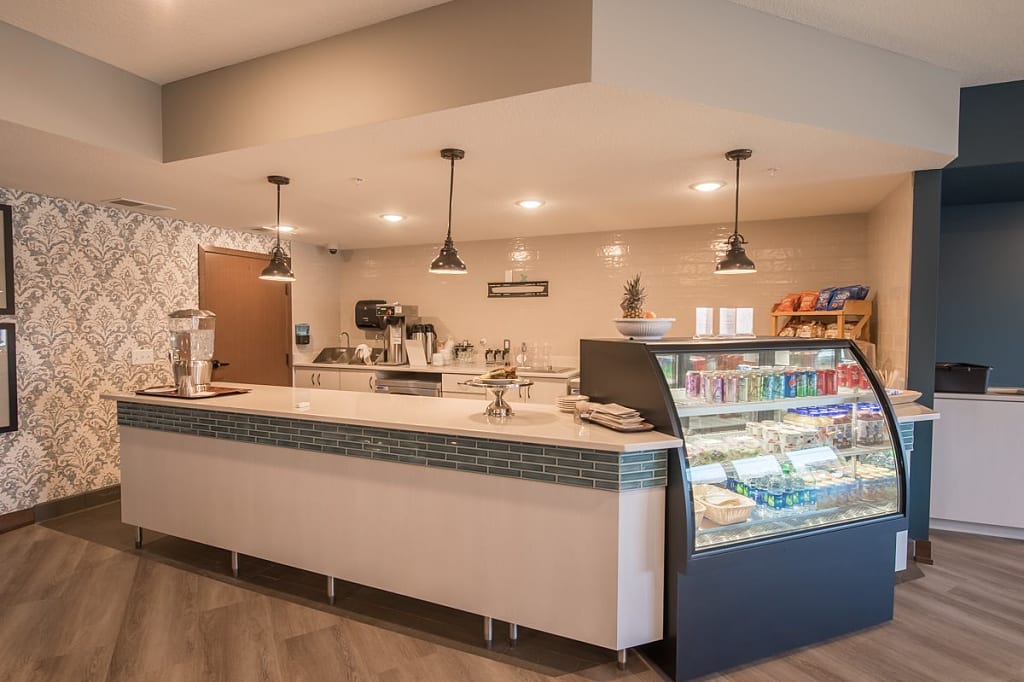 Bright cafe kitchen with display case and countertops.