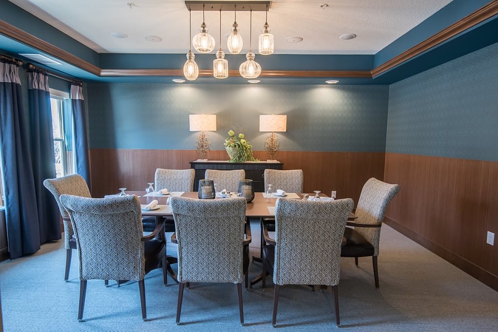 Intimate dining room with pendant lights and a table with chairs.