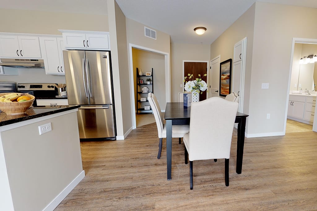Open concept unit with dining room and kitchen.